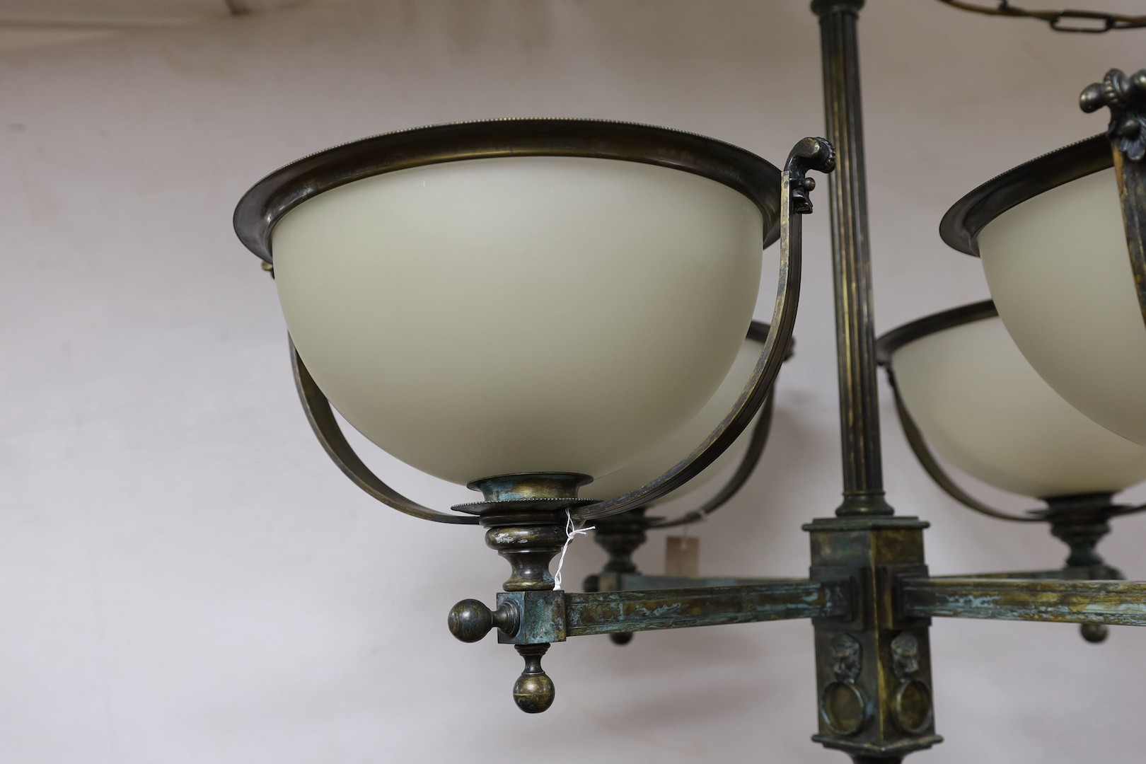 A brass 4 branch ceiling light with opaque glass shades, 72 cms high x 94 cms wide.